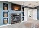 Comfortable living room with a modern fireplace, built-in shelving, and an open doorway at 1575 Ridgetrail Ct, Castle Rock, CO 80104