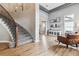 Bright living room with high ceilings, hardwood floors, and elegant staircase at 1575 Ridgetrail Ct, Castle Rock, CO 80104