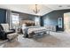 Spacious main bedroom with a large bed, soft carpet, and stylish furniture at 1575 Ridgetrail Ct, Castle Rock, CO 80104