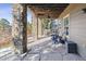 Covered patio with stone flooring and comfortable seating at 1575 Ridgetrail Ct, Castle Rock, CO 80104