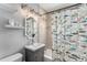 Cozy bathroom with a shower-tub combination and vanity, complemented by the patterned shower curtain at 1534 Rosemary St, Denver, CO 80220