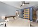 Bright bedroom with a wooden headboard, a ceiling fan, and a sliding barn door at 1534 Rosemary St, Denver, CO 80220