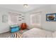 Charming bedroom featuring two bright windows and a colorful trunk to complement the space at 1534 Rosemary St, Denver, CO 80220