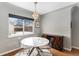 Bright dining area featuring a modern marble table, clear chairs, and a decorative light fixture at 1534 Rosemary St, Denver, CO 80220