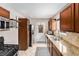 Functional kitchen featuring granite counters, tiled backsplash, and stainless steel appliances at 1534 Rosemary St, Denver, CO 80220