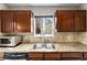 Bright kitchen featuring granite countertops, stainless steel sink, and ample cabinet space at 1534 Rosemary St, Denver, CO 80220