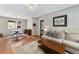 Cozy living room featuring hardwood floors, a decorative rug, and comfortable seating area at 1534 Rosemary St, Denver, CO 80220
