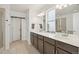A modern bathroom features a double sink vanity, white countertops, and a glass-enclosed shower at 545 High Point Dr, Longmont, CO 80504