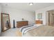 Bright bedroom with a simple bed frame, wooden dressers, and a floor mirror at 545 High Point Dr, Longmont, CO 80504