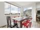 Bright dining area features a wooden table, red chairs, and a large window with city views at 545 High Point Dr, Longmont, CO 80504