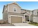 Exterior shot featuring a well-kept yard and a brown two-car garage door at 545 High Point Dr, Longmont, CO 80504