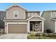 Charming two-story home featuring a covered porch, attached garage, and neutral-toned siding at 545 High Point Dr, Longmont, CO 80504