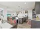 Open-concept kitchen with an island, flowing into the living and dining areas at 545 High Point Dr, Longmont, CO 80504