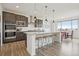 Modern kitchen featuring stainless steel appliances, granite countertops, and a large island at 545 High Point Dr, Longmont, CO 80504