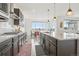 Spacious kitchen with dark cabinets, granite counters, and stainless steel appliances at 545 High Point Dr, Longmont, CO 80504