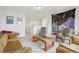 Spacious living area featuring neutral walls, plush seating, and an eye-catching tapestry at 545 High Point Dr, Longmont, CO 80504