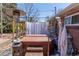 Cozy backyard featuring a hot tub, privacy curtains, and an outdoor heater at 12375 W 19Th Pl, Lakewood, CO 80215
