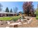 Landscaped backyard featuring a garden bed, a decorative windmill, and a covered patio at 12375 W 19Th Pl, Lakewood, CO 80215