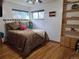 Cozy bedroom featuring hardwood floors, a ceiling fan and natural light from two windows at 12375 W 19Th Pl, Lakewood, CO 80215