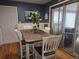 Bright dining area with a wooden table, white chairs, and access to a screened porch with a grill at 12375 W 19Th Pl, Lakewood, CO 80215