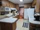 Cozy kitchen featuring wood cabinets, laminate countertops, and vinyl floors at 12375 W 19Th Pl, Lakewood, CO 80215