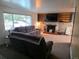 Comfortable living room with a stone fireplace, built-in shelving, and a large window at 12375 W 19Th Pl, Lakewood, CO 80215