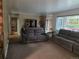 Spacious living room featuring plush sofas, carpet floors, and a large window with plenty of sunlight at 12375 W 19Th Pl, Lakewood, CO 80215