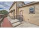 A backyard patio that has wood like tile with a side entrance and metal railing at 2789 Decatur Dr, Broomfield, CO 80020