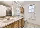 Bathroom with double sink vanity, large mirrors, and ample lighting at 2789 Decatur Dr, Broomfield, CO 80020