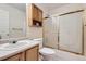 Bathroom featuring a shower, toilet, cabinet, and sink at 2789 Decatur Dr, Broomfield, CO 80020