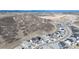 An aerial view of a suburban neighborhood with a winding road and mountain backdrop at 865 Oleander St, Castle Rock, CO 80109
