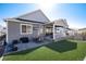 A covered patio with backyard featuring artificial turf, and an outdoor dining area at 865 Oleander St, Castle Rock, CO 80109