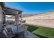 Backyard featuring a covered patio, outdoor dining area, and artificial turf for easy maintenance and enjoyment at 865 Oleander St, Castle Rock, CO 80109