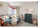 Stylish bedroom features a cozy bed, hanging swing chair, decorative floral decals, and a charming window view at 865 Oleander St, Castle Rock, CO 80109