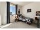 Inviting bedroom features a window with gray curtains, checkered bedding, and a cozy chair, creating a relaxing retreat at 865 Oleander St, Castle Rock, CO 80109