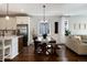 The dining area features a wood table with bench seating and a view of the stainless steel kitchen appliances at 865 Oleander St, Castle Rock, CO 80109