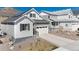 Charming single-Gathering home featuring a white garage door, a modern gray facade and minimalist landscaping at 865 Oleander St, Castle Rock, CO 80109