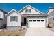 Well-maintained single-Gathering home featuring manicured front lawn and gray and white facade at 865 Oleander St, Castle Rock, CO 80109