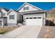 Charming single-Gathering home featuring a white garage door and a manicured, minimalist front yard at 865 Oleander St, Castle Rock, CO 80109