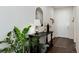 Warm, inviting foyer with dark console table, modern decor, and neutral walls at 865 Oleander St, Castle Rock, CO 80109