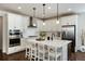 Bright, open kitchen featuring an island with bar stool seating and modern stainless appliances at 865 Oleander St, Castle Rock, CO 80109