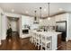 Bright, open kitchen featuring an island with bar stool seating and modern stainless appliances at 865 Oleander St, Castle Rock, CO 80109