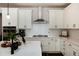 This kitchen features white cabinetry, modern stainless steel appliances, and a subway tile backsplash at 865 Oleander St, Castle Rock, CO 80109