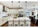 Bright, open kitchen featuring an island with bar stool seating and modern stainless appliances at 865 Oleander St, Castle Rock, CO 80109