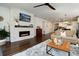 Open floor plan with a modern living room featuring hardwood floors, a cozy fireplace, and an open view of the kitchen at 865 Oleander St, Castle Rock, CO 80109