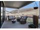 Covered patio with comfortable seating, offering a relaxing outdoor space with scenic hillside views at 865 Oleander St, Castle Rock, CO 80109