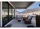 Covered patio with comfortable seating, offering a relaxing outdoor space with scenic hillside views at 865 Oleander St, Castle Rock, CO 80109