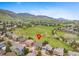 Aerial view showcasing the home's location backing onto a large grassy field with mountain views at 9 Amaranth Dr, Littleton, CO 80127