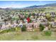Wide aerial perspective revealing the property's place among homes with views of distant mountains at 9 Amaranth Dr, Littleton, CO 80127