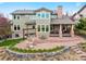 Expansive backyard featuring a stone patio, lush lawn, and a charming pergola at 9 Amaranth Dr, Littleton, CO 80127